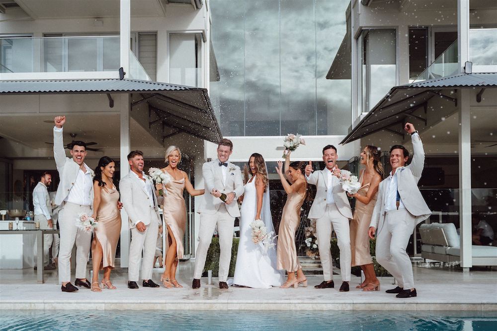 Noosa bridal party popping champagne by the pool