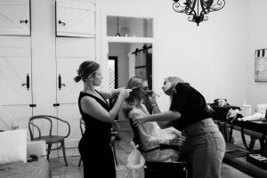 black and white image of bride getting hair and makeup done hinterland wedding