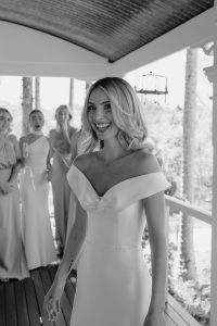 bridesmaids first look bride in wedding gown