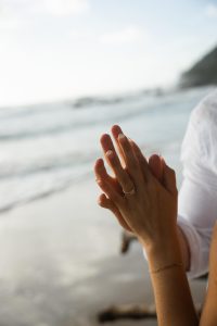 how much should you spend on an engagement ring couple holding hands wearing engagement ring