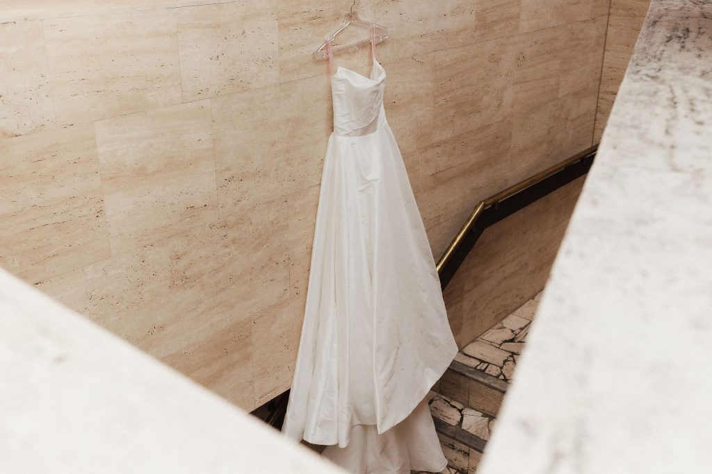 wedding gown hung in stairwell
