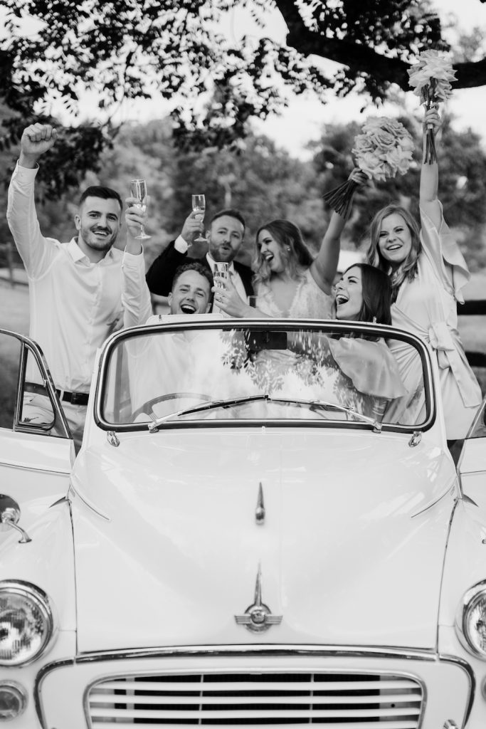 Bridal party in vintage wedding car