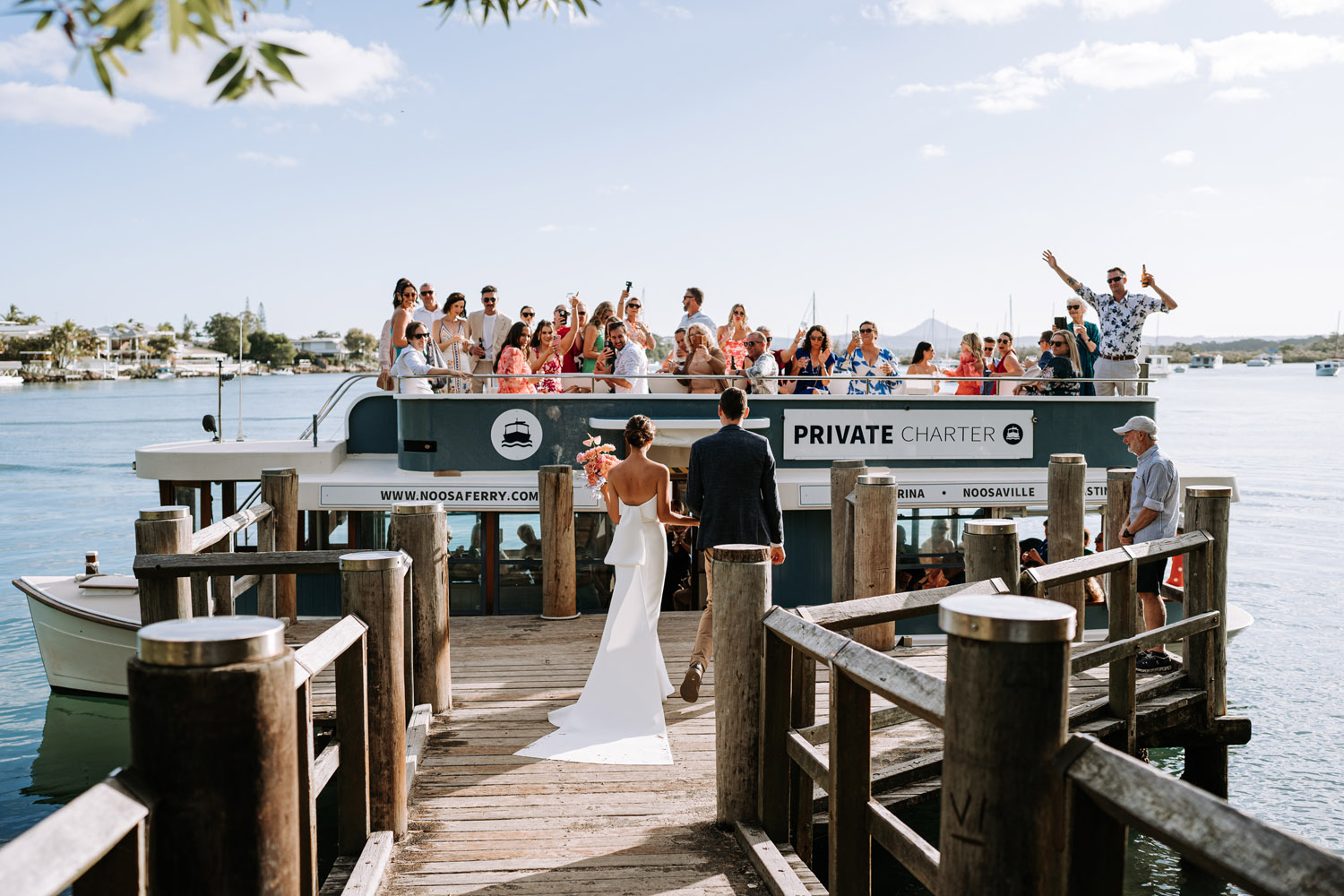 Noosa wedding venue Noosa Boathouse jetty where a bride and groom green their guests on the Noosa Ferry