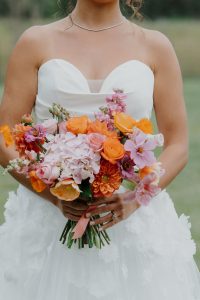 bride holding bright warm bridal bouquet