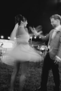 black and white image of bride and groom dancing at their Sunshine Coast wedding reception