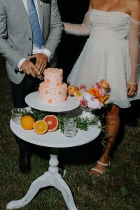 peach coloured wedding cake with citrus and floral styling