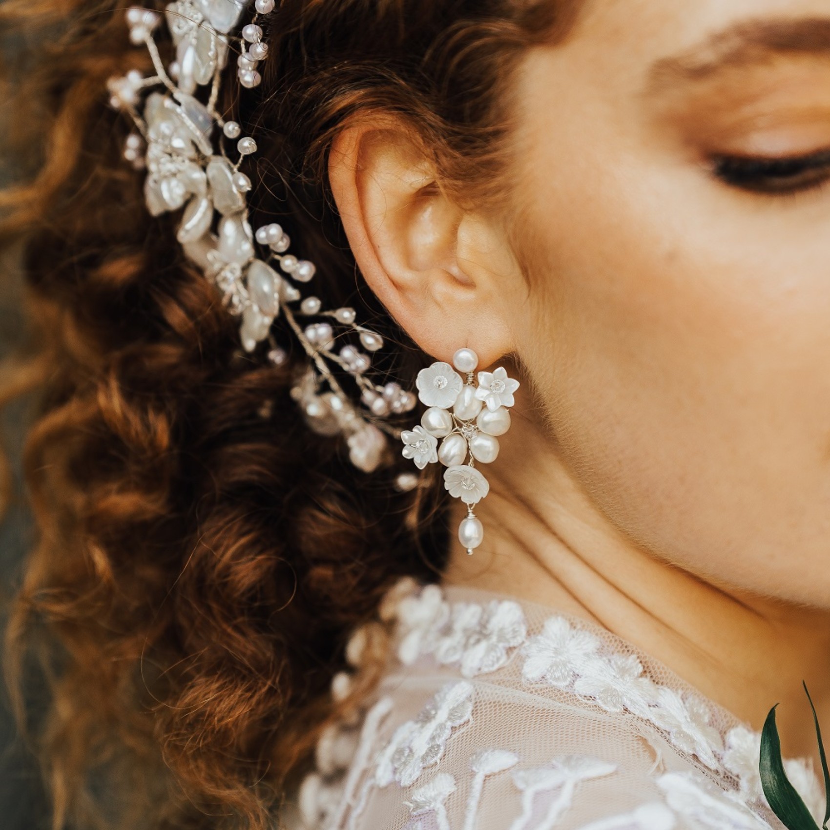 close up of pearl hair accessory and pearl earrings on brie