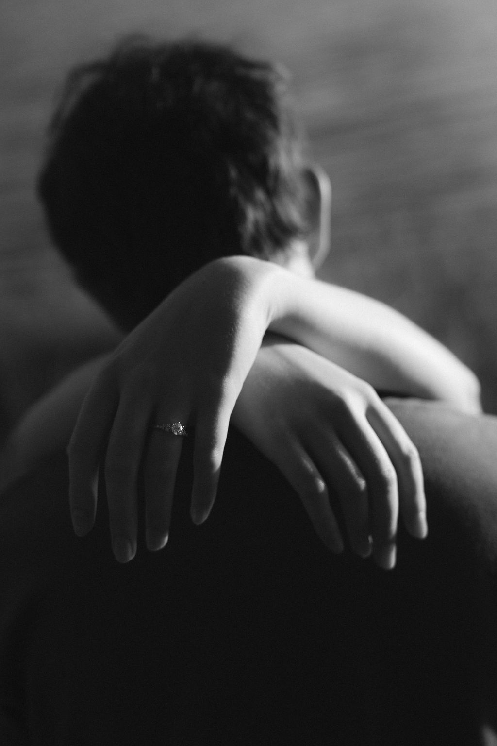 engagement shoot in black and white with engagement ring in the foreground
