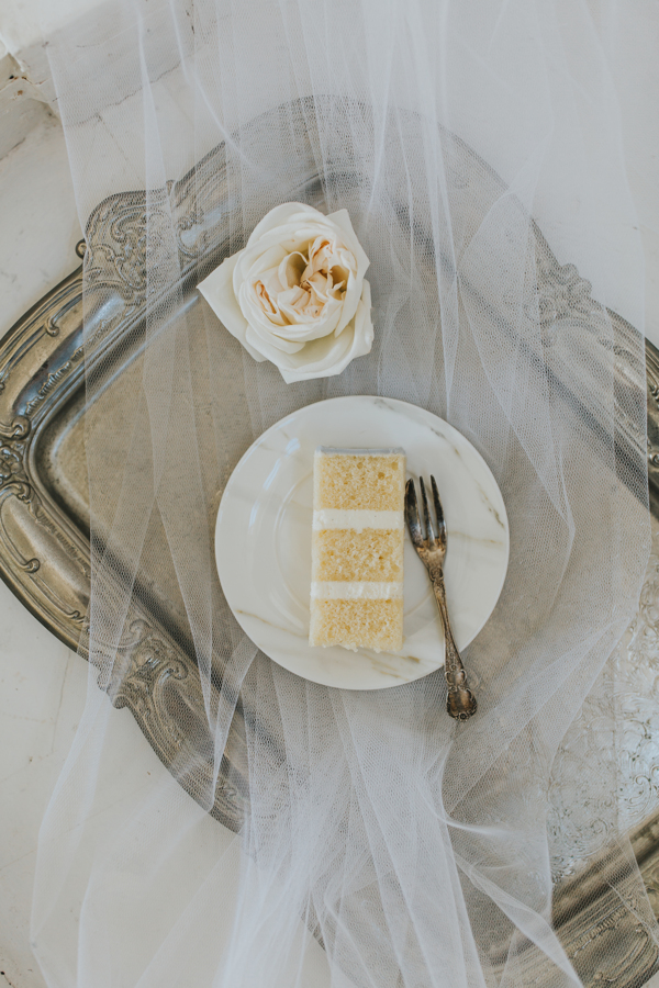 slice of wedding cake on silver tray