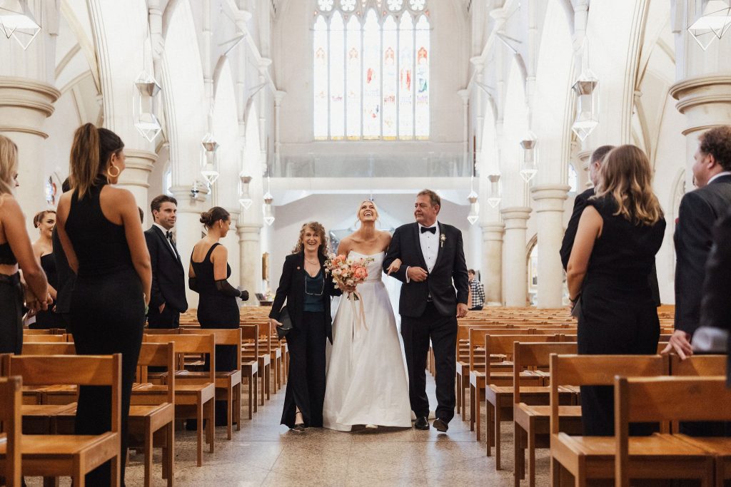 Bride and her parents walking down the aisle in Cathedral in Brisbane