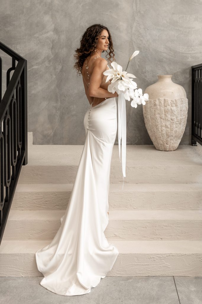 Bridal fashion model wearing white slinky dress