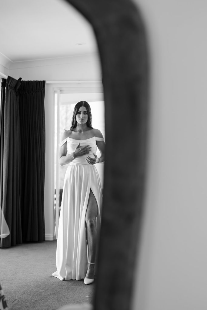 Bride getting dressed in wedding dress and shoes on wedding day morning in Noosa