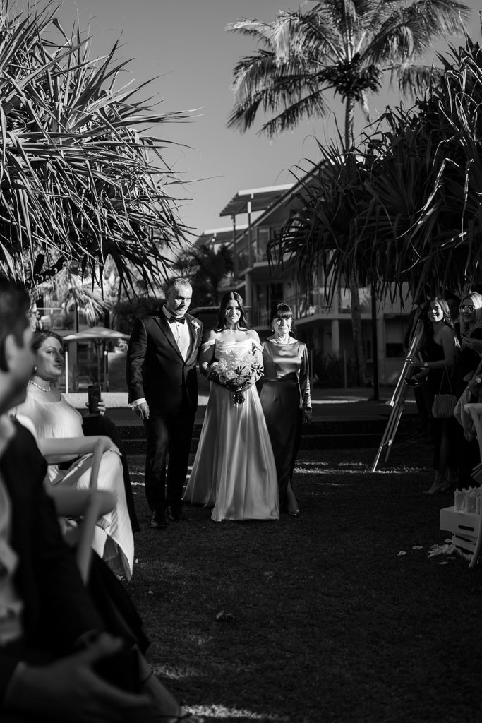 Black and white image of bride walking down the aisle at Maison La Plage Noosa