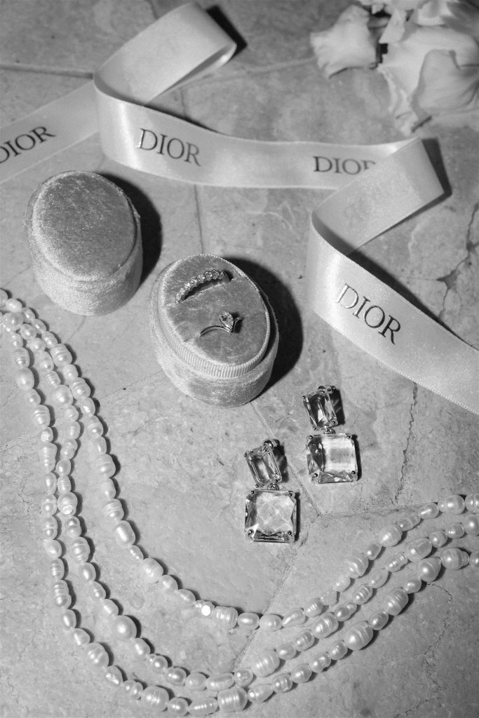 Wedding jewellery flat lay in black and white image with Dior ribbon