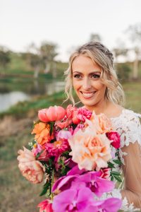 Bright pink and orange bouquet with dahlias, peonies, and orchids by Sunshine Coast hinterland florist