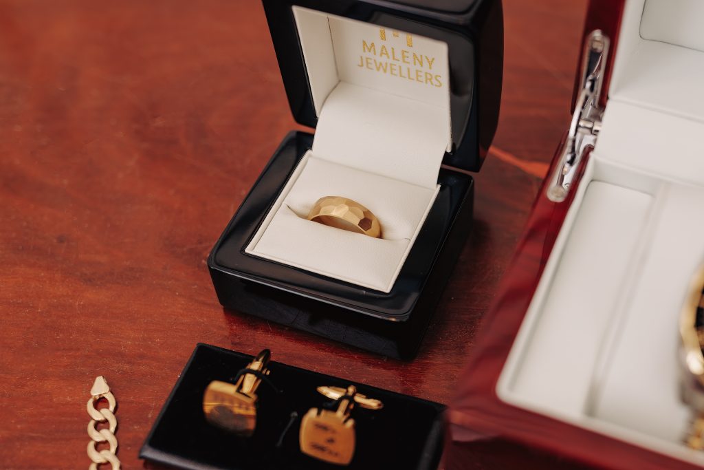groom cufflinks and wedding band layout for sunshine coast wedding