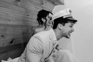 bride and groom having fun with props in vintage caravan photo booth sunshine coast Peninsula Pop Ups