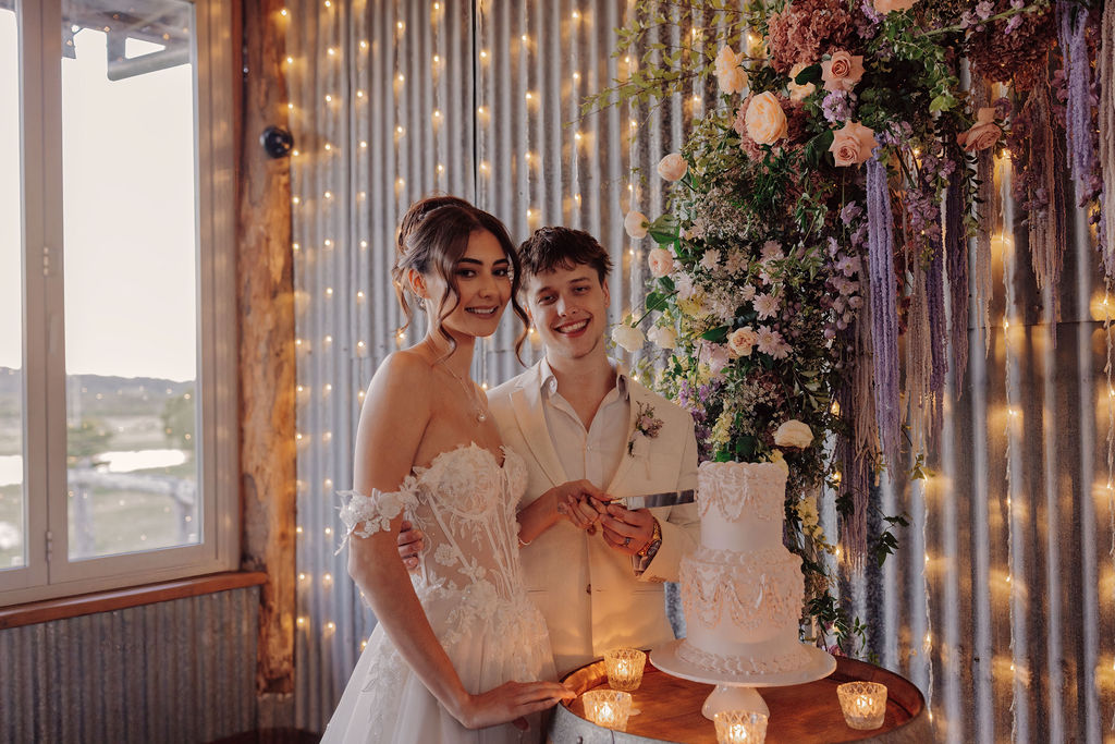 bride and groom cutting wedding cake at Yandina Station wedding venue sunshine coast